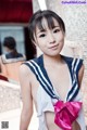 A woman in a sailor outfit posing for a picture.