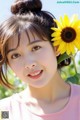 A young woman with a sunflower in her hair.