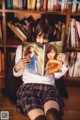 A woman sitting on the floor reading a book.