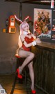 A woman in a bunny costume sitting at a bar.