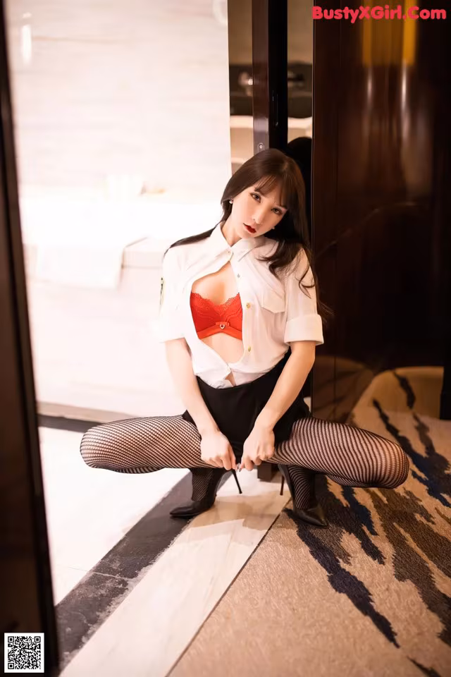 A woman in a police uniform is posing for a picture.