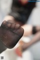 A close up of a woman's feet in black stockings.