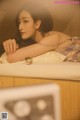 A woman laying on top of a bed next to a microwave.